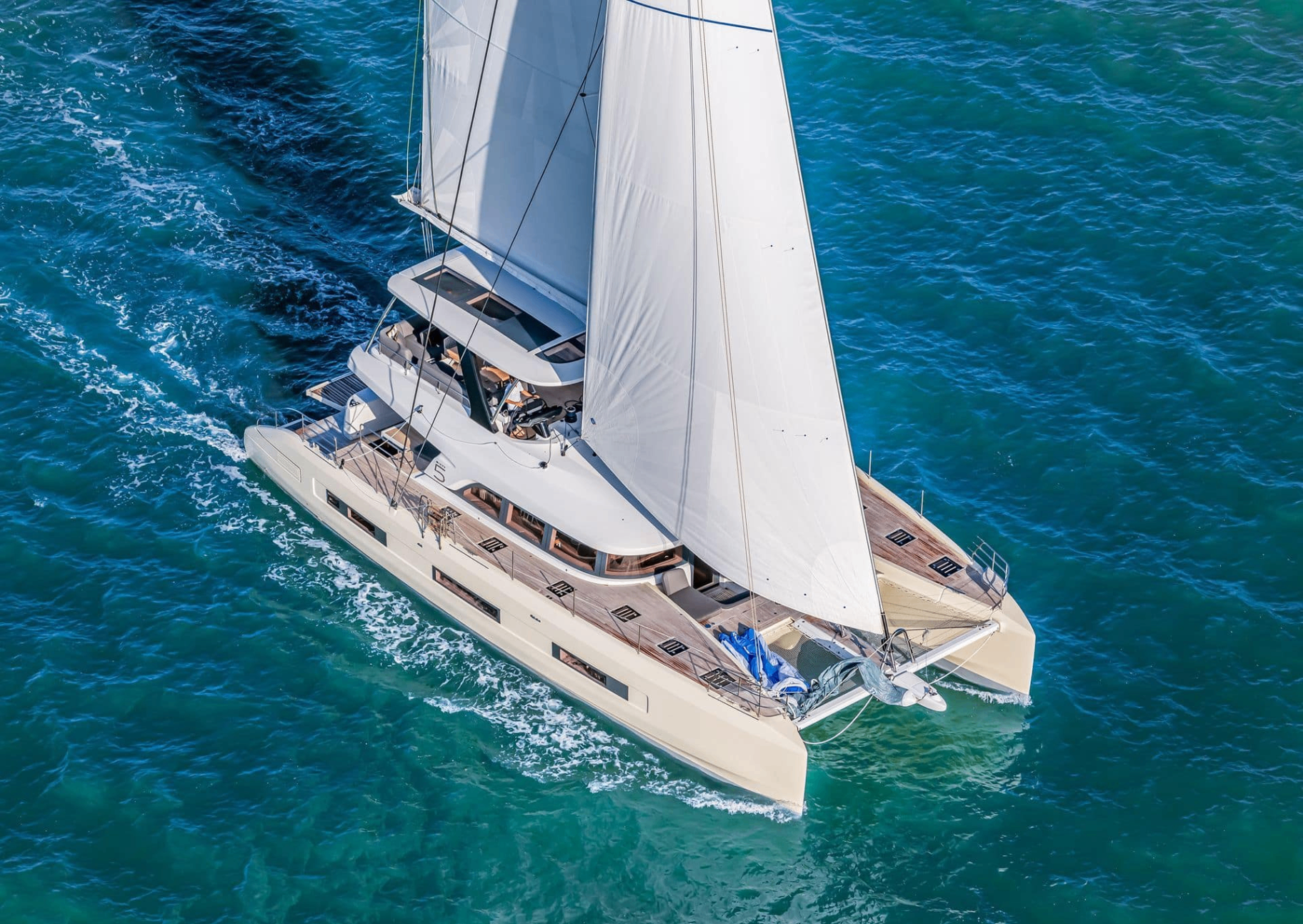 Fountaine Pajot Samana 59 sailing catamaran underway with full sails in turquoise Mediterranean water